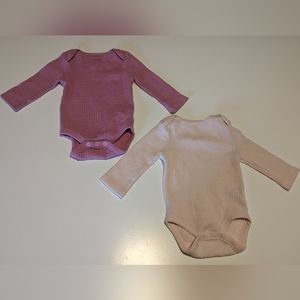 Two long-sleeved pink onesies